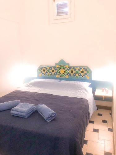 a bedroom with a bed with two pillows on it at Dammuso Cinzia, incantevole fronte mare in Pantelleria