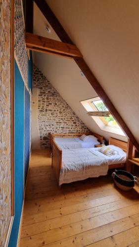 a bedroom with a bed in a attic at Plantation de poivre- La Petite Rivière in Saint-Maurice-en-Cotentin