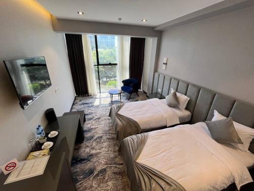 Ένα ή περισσότερα κρεβάτια σε δωμάτιο στο UNIQUE HOTEL