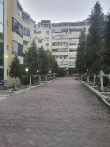 an empty street in front of a large building at Lavender Home in Golem