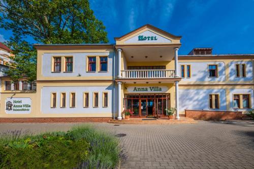 a large white building with a sign on it at Hotel Anna Villa in Balatonföldvár