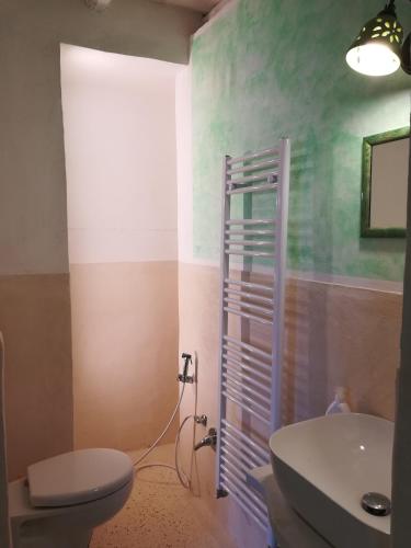 a bathroom with a toilet and a sink at Dimora Maltese in Morciano di Leuca