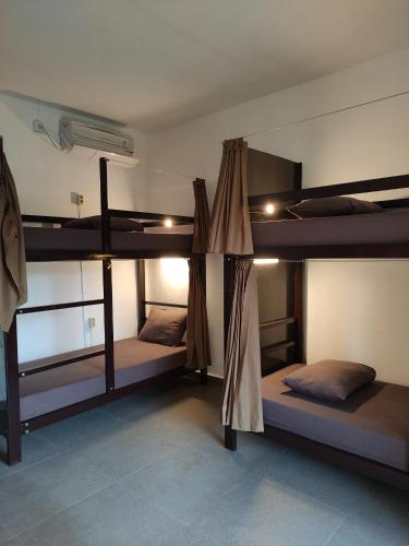 a room with three bunk beds in it at Karma Backpacker in Uluwatu