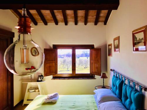a bedroom with a bed and a window at Podere San Francesco in Bolsena