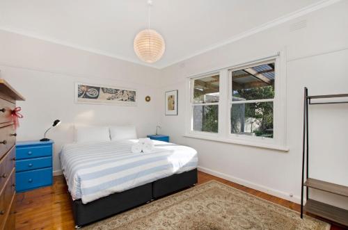 a bedroom with a bed and a window at Deckhouse in Port Fairy