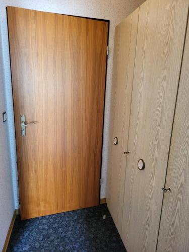 a wooden door in a room with two closets at Hotel Zur Schanze in Wieda