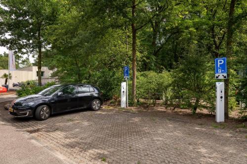 a car parked in a parking lot with parking signs at Stayokay Hostel Soest in Soest