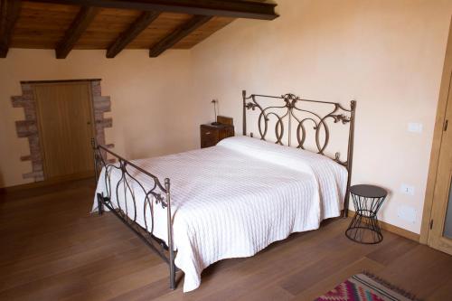 a bedroom with a bed with a white bedspread at Agriturismo La Burlanda in Fosdinovo