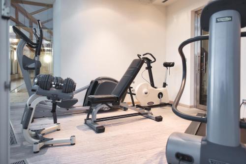 a gym with cardio equipment in a room at Hotel Gasthof Stern in Nova Ponente