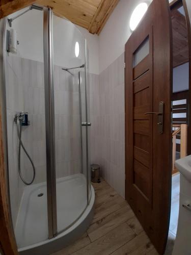 a bathroom with a shower and a toilet and a sink at Gospodarstwo agroturystyczne in Węgorzyno