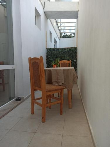 a table with two chairs and a table with a table cloth at Family Hotel Silitur in Ahtopol