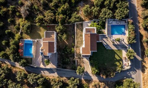 an overhead view of a house with two swimming pools at Villas Almyrida in Almyrida
