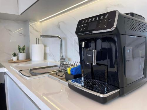a microwave oven sitting on top of a kitchen counter at Thea Luxury Apartment in Tolo