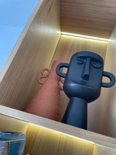 a shelf with a pair of scissors and a container at Thea Luxury Apartment in Tolo