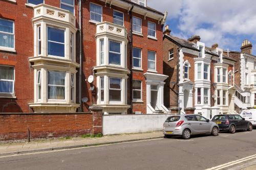 deux voitures garées devant un bâtiment en briques dans l'établissement Cormorant PLACE LUXURY PAD, à Portsmouth