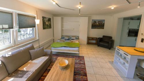 ein Wohnzimmer mit einem Sofa und einem Bett in der Unterkunft Appartement Micha in Weissach Im Tal