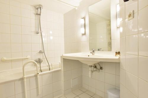 a white bathroom with a sink and a shower at MyContinental Bucuresti Gara de Nord in Bucharest
