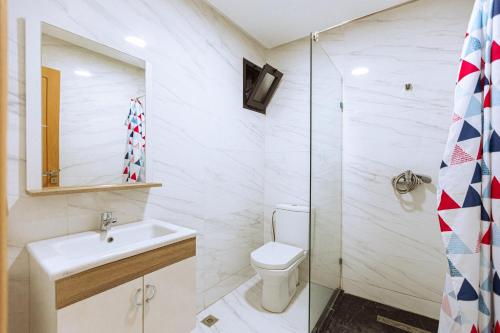 a bathroom with a toilet and a sink and a shower at EL NIDO ALHOCEIMA in Al Hoceïma