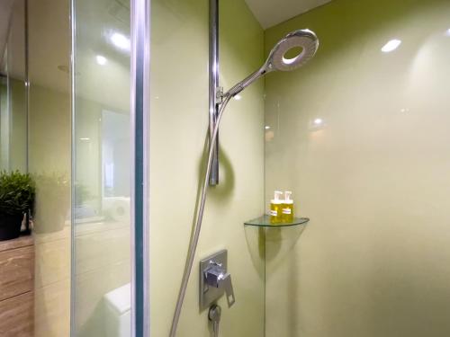 a shower with a shower head in a bathroom at vortex suites klcc by LEAVA in Kuala Lumpur