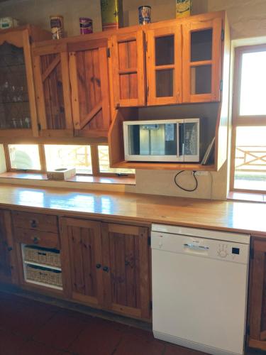 a kitchen with a counter top with a microwave at Kite View 2 Holiday Home in Witsand
