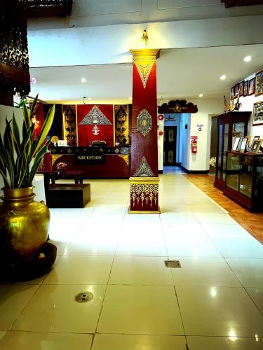 a lobby with a room with a table and a vase at Silver Resortel in Patong Beach