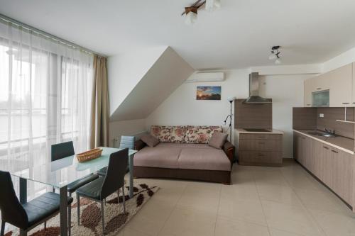a living room with a couch and a table at Art Apartments in Hajdúszoboszló