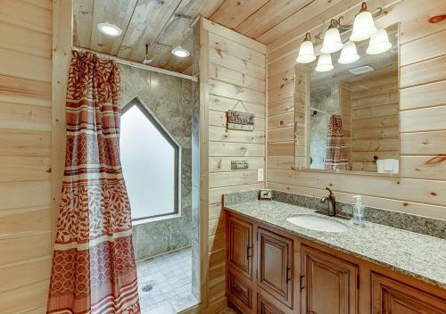 a bathroom with a sink and a mirror at Wooded ViewsNear Helen w Fireplace & Hot Tub in Cornelia