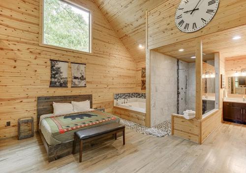 a bedroom with a bed and a clock on the wall at Cabin Near Helen, GA w Spa Amenities in Cornelia