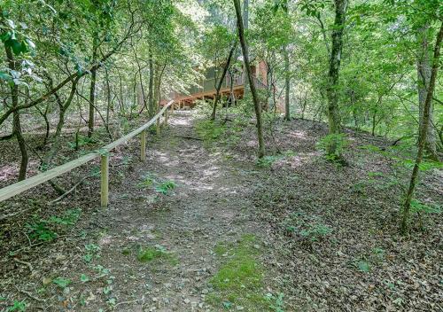 a dirt trail in the woods with a fence at 2 Person Jacuzzi Spa w Creekside Firepit in Cleveland