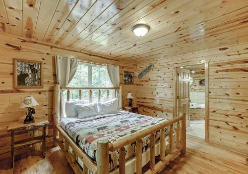 a bedroom with a bed in a log cabin at Private Luxury Cabin w Pool Table and Firepit in Cornelia