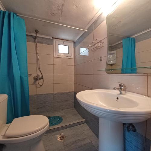 a bathroom with a sink and a toilet at Jerrys Home Agios Petros in Áyios Pétros