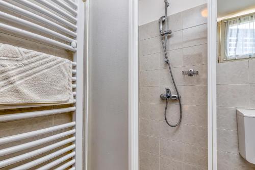 een badkamer met een douche en een toilet bij Matea Rooms in Funtana