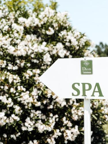 a stop sign in front of a flowering tree at Dion Palace Resort and Spa in Limani Litochorou