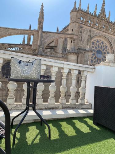 uma mesa em frente a um edifício com uma bolsa em Catedral Boutique em Sevilha