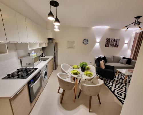 a kitchen and living room with a table and chairs at Marassi Marina 2 - Salt Lake Chalet in El Alamein