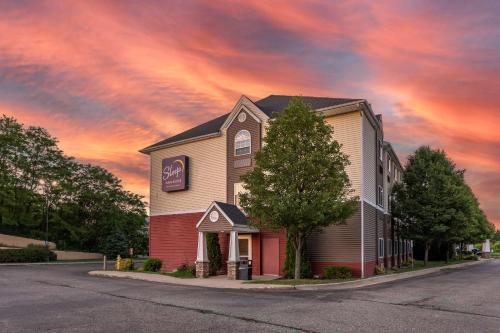 a church on a street under a cloudy sky at Sleep Inn & Suites in Kalamazoo