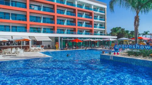 a large swimming pool in front of a hotel at Aquashow Park Hotel in Quarteira
