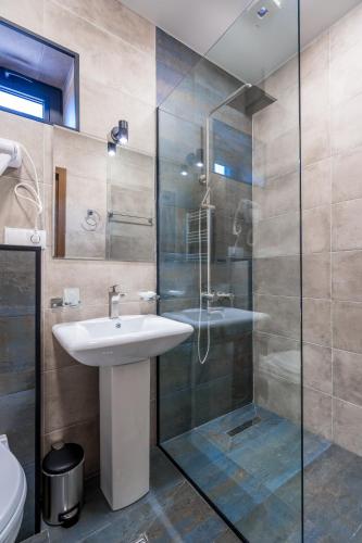 a bathroom with a sink and a shower at Hotel Darchi Kazbegi in Stepantsminda