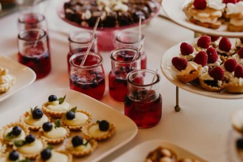 a table topped with plates of desserts and drinks at Hotel & Restauracja Timberland in Orzesze