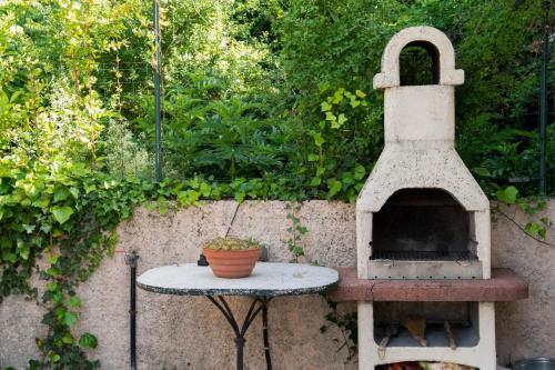a stone oven sitting on a table with a plant at L'Instant Provence in Valréas