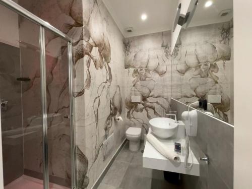 a bathroom with a shower and a sink and a toilet at Tribus Boutique Hotel in Torre Annunziata