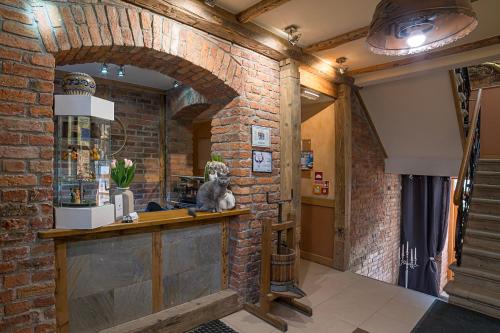 a brick room with a cat sitting on a counter at Villa Fortuna in Duszniki Zdrój