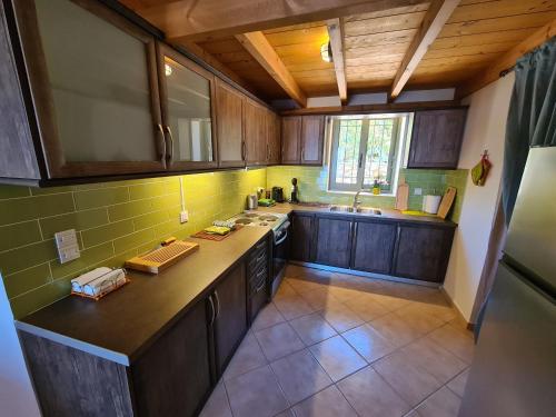 an overhead view of a kitchen with wooden cabinets at Leopolis Villas in Stoupa