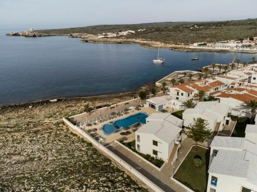 an aerial view of a house and the water at AluaSun Far Menorca in S'Algar