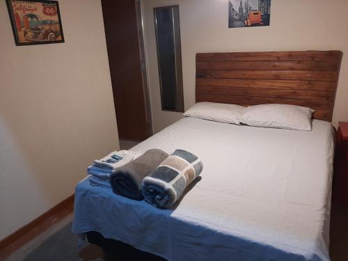 a bedroom with a bed with towels on it at Kitnet - Apart Hotel 2 in Sete Lagoas