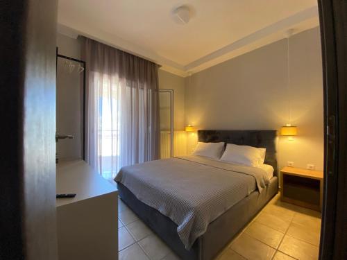 a hotel room with a bed and a window at Hellen's Apartments in Ofrínion
