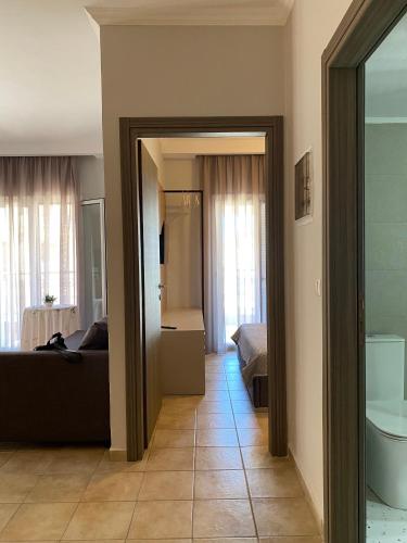 a living room with a couch and a bathroom at Hellen's Apartments in Ofrínion