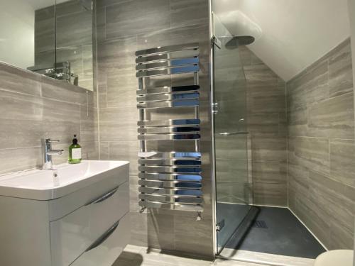 a bathroom with a shower and a sink at The Nook- A Rustic Cottage in a Beautiful Village. in Draycott