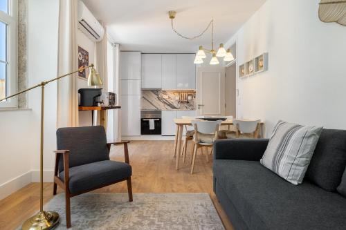 a living room with a couch and a table at Modern Lisbon Apartments by Soulplaces in Lisbon