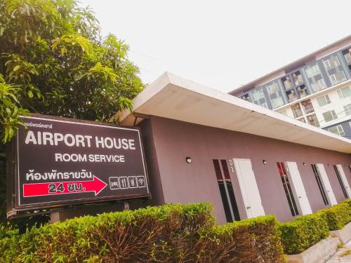 an airport house room service sign in front of a building at airport house in Bangkok